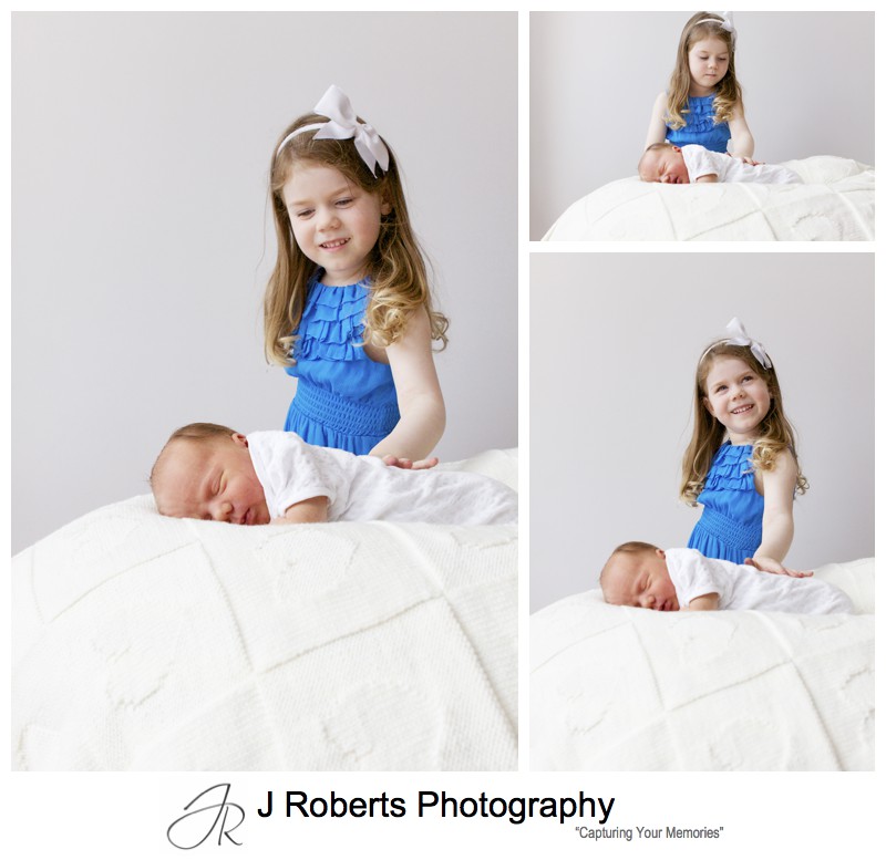 Big sister loving her newborn baby brother - newborn portrait photography sydney